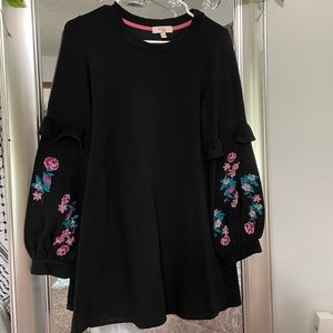 black shirt with floral print on the sleeves
